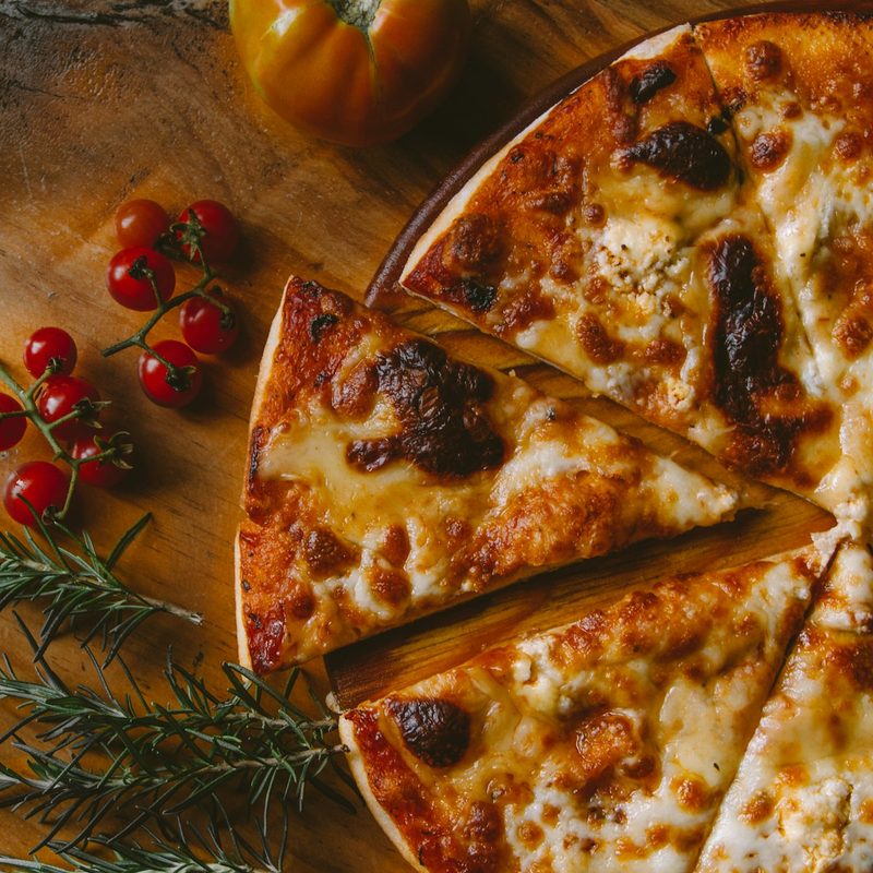 Roman-style pizza on a wooden board at Lucky Mama's